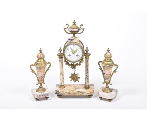 A late 19th Century French marble clock garnitureThe drum style clock with a 9cm enameled dial raised on marble columns and i
