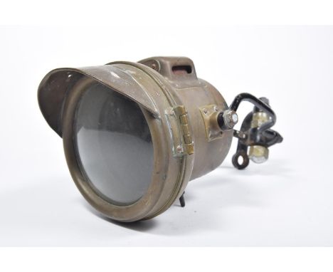 A 1930s carbide motorcycle lampFitted with iron handlebar bracket, lamp diameter 16cm. 