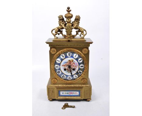 A late 19th Century gilt metal and Sevres style porcelain panel eight day mantle clockThe architectural gilt case detailed wi