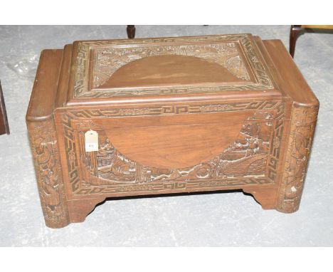 A 20th Century Chinese carved camphor wood chestThe stepped rectangular top carved in deep relief with a pagoda landscape and