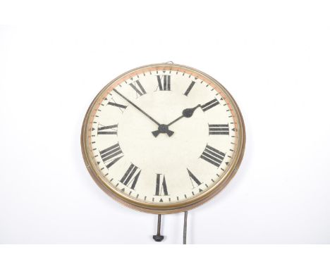 An early 20th Century electric wall clockThe 28cm white dial painted with Roman numerals within a brass bezel, the electric c