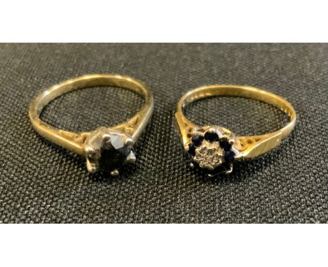 A sapphire and diamond flower head cluster ring, 18ct gold shank, size N, 2.7g gross;  a deep blue sapphire solitaire ring, u