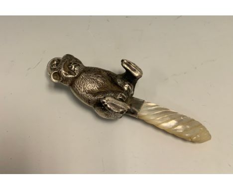 A novelty silver and mother-of-pearl baby's rattle, as bear, 12cm long, apparently unmarked, 20th century 