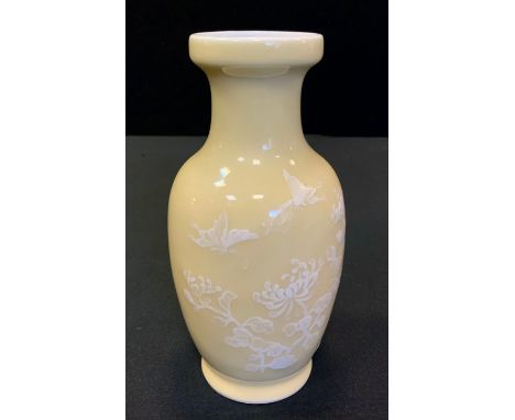 A 20th century Chinese vase, enamelled in white with stylised foliage, on a light yellow ground, 17cm high, seal mark 