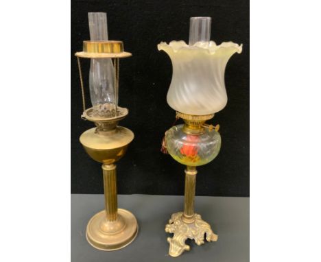 A Victorian brass and clear glass oil lamp, shaped tripod foot, frosted shade, another brass reservoir, both 61cm high (2) 