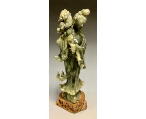 A Chinese spinach jade figure, Guan Yin, standing, pierced base, 11.5cm high 