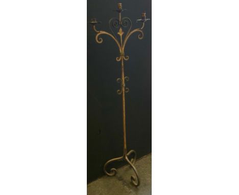 A floor standing cast iron 'Gothic; three light candleabrum, gilt painted, 147cm high 