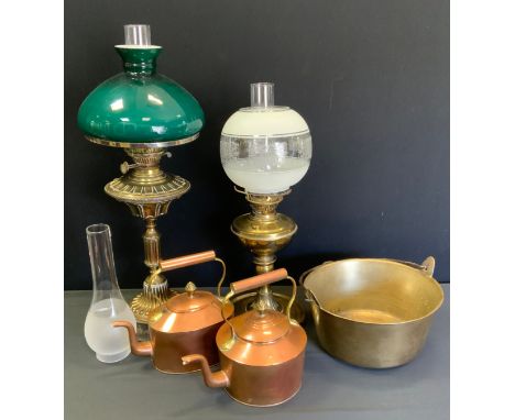 A Victorian brass oil lamp, embossed reservoir, stepped column, green shade, 67cm high overall;  another smaller, 54cm high; 