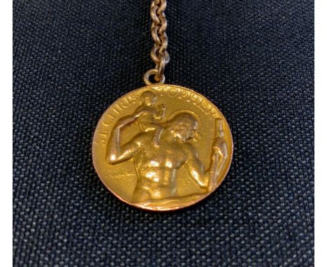 Betty Davis interest - a nine carat gold St. Christopher's medallion, 5.1g, suspended on a base metal key ring, the back insc