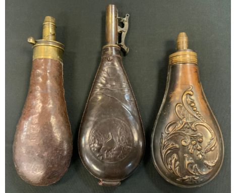 A 19th century leather shot flask, embossed with a roundel of game birds, 22cm long; others (3) 