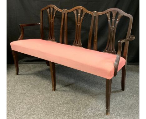 An Edwardian three-seat mahogany sofa, wheat-sheaf splats, tapered square legs, c. 1905. 