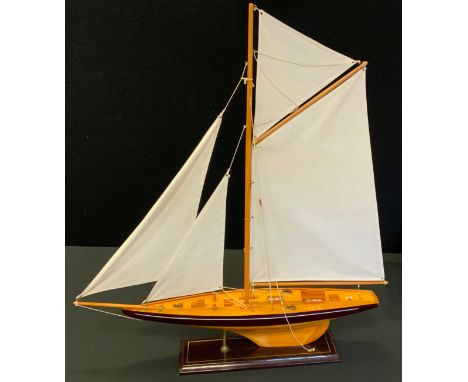 A model Yacht, single mast, wooden hull, 81cm high, 71cm long, with stand 