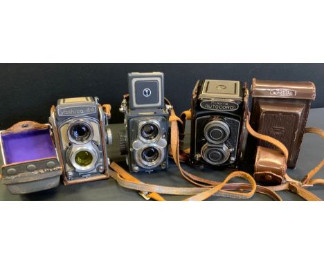 A Minolta Autocard camera, cased;  Yashica Mat twin lens reflex camera;  Yashica - 44 twin lens camera;  etc 