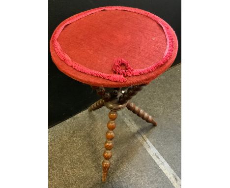 A late Victorian bobbin turned gypsy table, on tripod legs and associated top upholstered with a red fabric with fringed bord