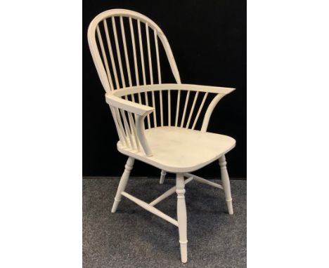 A white stick back Windsor style side chair 