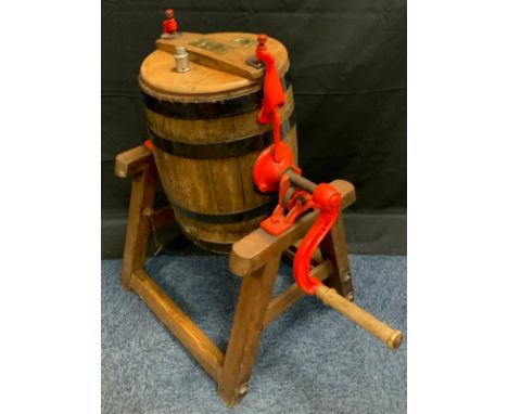 An early 20th century coopered oak butter churn, on stand, painted red ironwork, approx 80cm high 