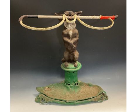 A 19th century Coalbrookdale novelty cast iron stick stand, in the form of a dog on its hind legs holding a whip in its mouth