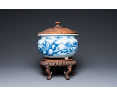 Full title: A Chinese blue and white 'landscape' tripod censer with later wooden cover and stand, KangxiDescription:Dia.: 24,