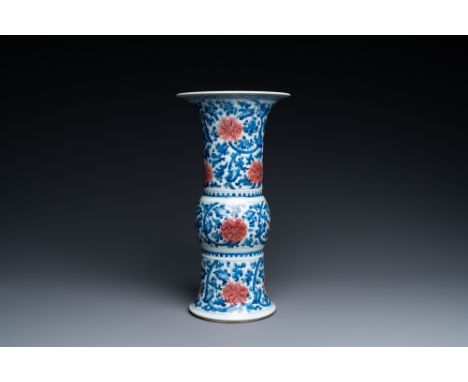 Full title: A Chinese blue, white and copper-red 'gu' vase with lotus scrolls, KangxiDescription:H.: 38,5 cmÊ Condition: (UV-