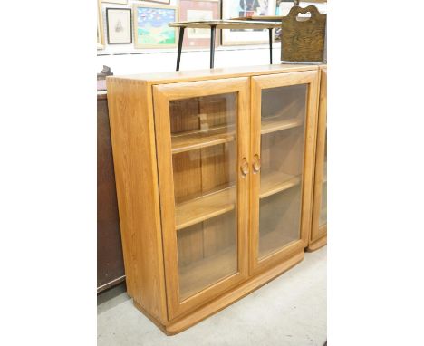 Ercol Pale Elm Bookcase / Display Cabinet with two bevelled glazed doors enclosing adjustable shelves, 91cm long x 98cm high