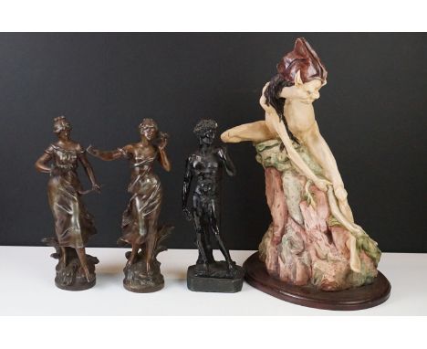 A collection of three cast metal figures of classical form together with a resin figure from Lord of the Rings. 