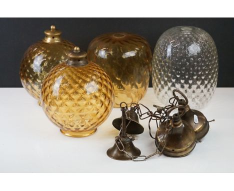 Three amber glass textured lamp shades together with a clear example and a quantity of fittings. 