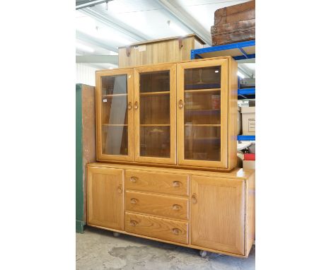 Ercol Light Elm Bookcase / Display Cabinet with three bevelled glazed doors opening to adjustable shelves, over an Ercol mode