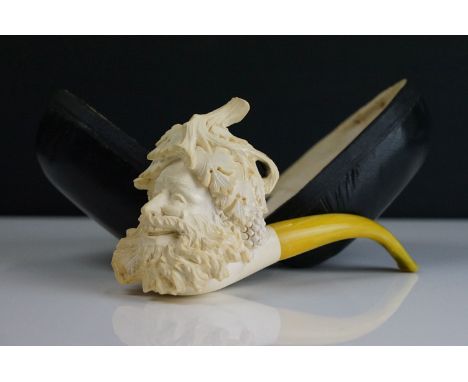 A cased Meerschaum smokers pipe with carved head bowl and yellow amber mouthpiece. 