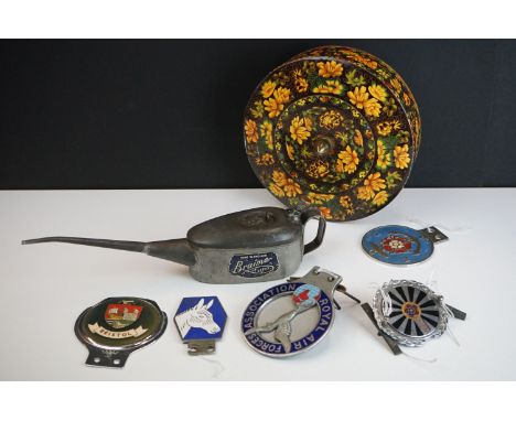 A collection of four car grill badges to include Bristol and Royal Air Force Association examples together with a vintage oil