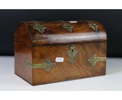 Victorian Walnut Domed Stationery Box with brass strapwork mounts, the hinged lid opening to a fitted stationery rack, inkwel