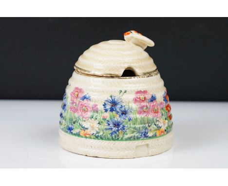 Clarice Cliff Pottery Beehive Honey Pot in the Radiance pattern (damage to wing of bee), 11cm high 