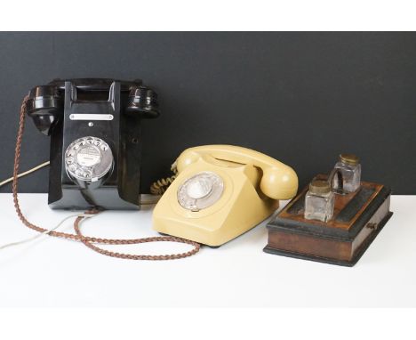 Two vintage B.T. home telephones together with a desk stand with inkwells. 