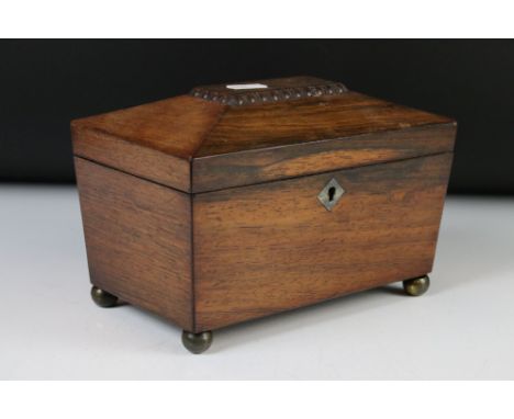 Regency Rosewood Tea Caddy of sarcophagus form, raised on brass ball feet, 21cm wide 