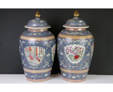Pair of Chinese Ceramic Famille Rose Baluster Jars with Covers, the blue ground decorated with panels of figures and panels o