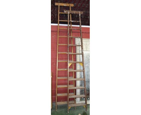 A twelve step set of thatcher's ladders; another, eleven step. (2)