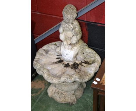 Garden statuary- a shell shaped bird bath with a faun playing the pipes