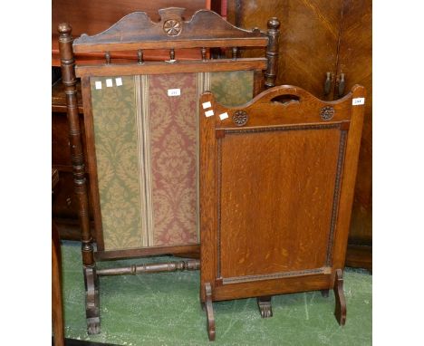 A Victorian oak firescreen, turned supports, c1880; a 20th century oak carved firescreen 