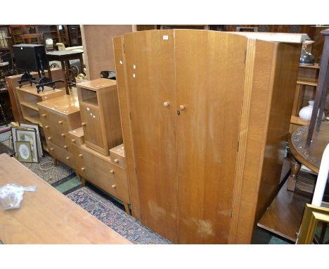 An Advance Furniture light oak four piece bedroom suite comprising double wardrobe, dressing chest, four drawer chest and bed