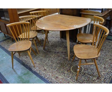 An Ercol style light elm circular dropleaf table and five spindle back chairs (6)