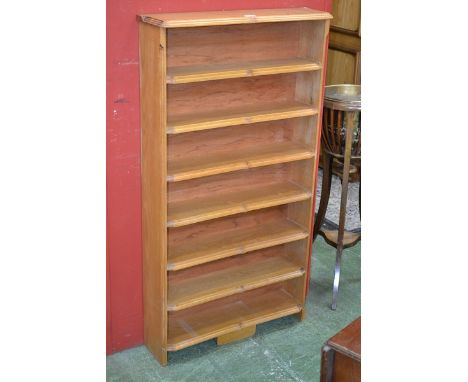A light oak six tier bookcase, of small proportions.  124.5cm high x  67.5cm wide x 18.5cm deep.