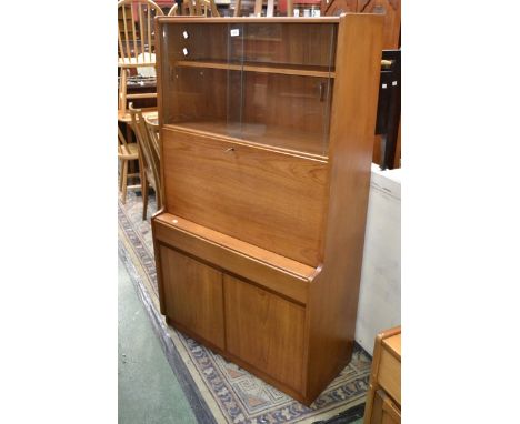 A Remploy furniture teak bureau bookcase. two sliding glass doors over fall front enclosing fitted interior, two short drawer