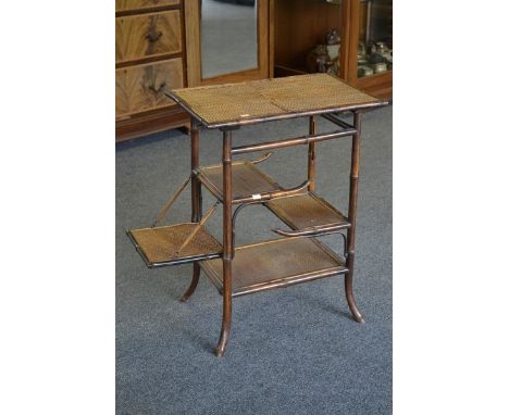 A late 19th/early 20th century rattan and bamboo colonial table, folding side shelf
