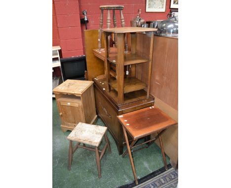 An oak occasional table; three stools; a pine bedside cabinet; a 1950's bookcase, two sliding glass doors over two door cupbo