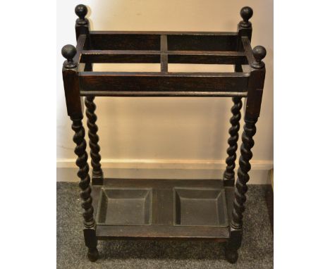 An early mid 20th Century oak barley twist walking stick stand, metal liners to base