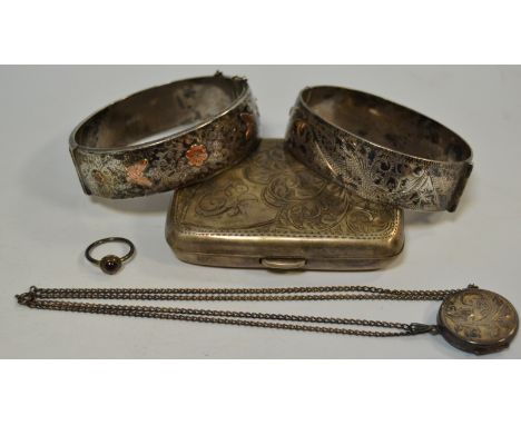 A silver hinged bangle, engraved and chased with foliate scrolls;  another;  a silver cigarette case;  etc, 6oz