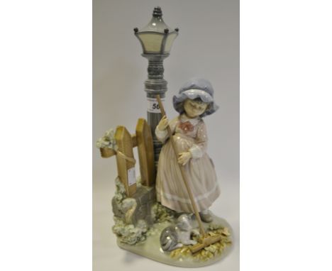 A Lladro figure of a Girl sweeping leaves, a Kitten playing at her feet 