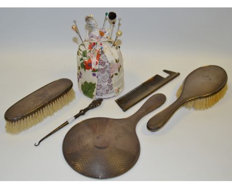 Ladies Ephemera - a silver engine turned dressing table set; a German half doll hat pin holder; a Victorian silver buttonhook