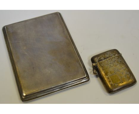 A silver vesta case, chased and engraved overall, Birmingham 1924, 31.4g; a silver engine turned cigarette case, 171.6g, Lond