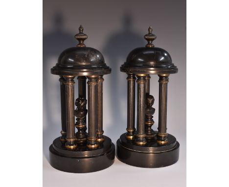 A pair of late 19th century dark patinated and belge noir library porticos, each cupola with knop finial above a portrait bus