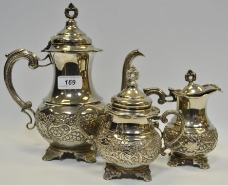 A silver coloured three piece tea service, embossed with fruiting vine, pierced finial , presented to Simpkin and Co, by Sial